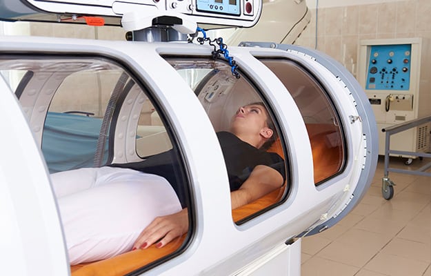 Girl-patient-lying-in-a-hyperbaric-chamber.-What-Is-Hyperbaric-Oxygen-Therapy
